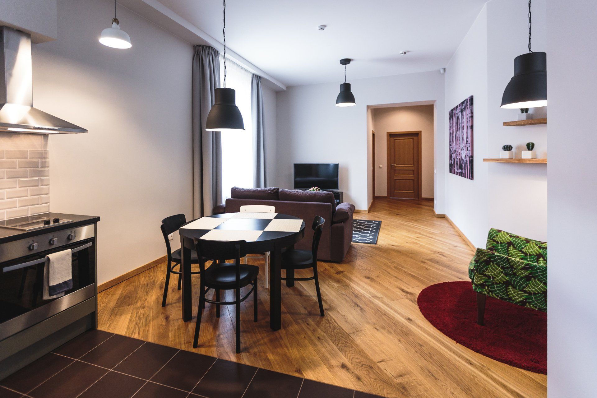 A kitchen with a table and chairs in it
