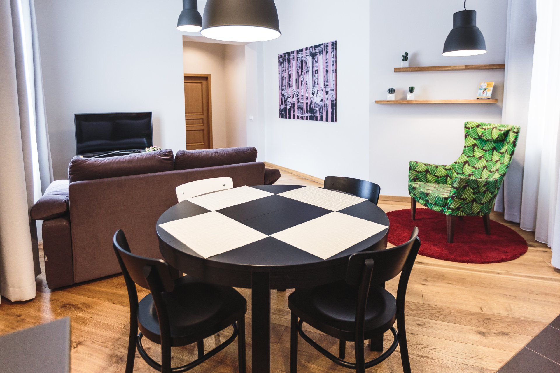 A living room with a dining table and chairs