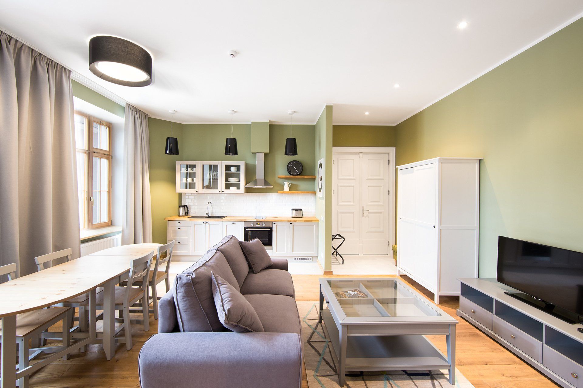 A living room with a couch , table and television.