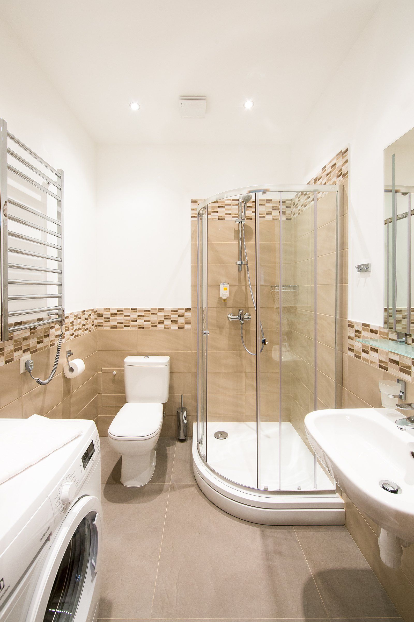A bathroom with a toilet , sink , and shower stall.