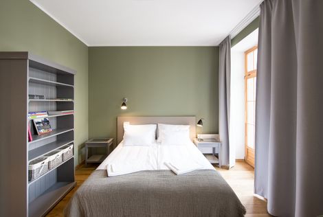 A bedroom with a bed and a bookshelf