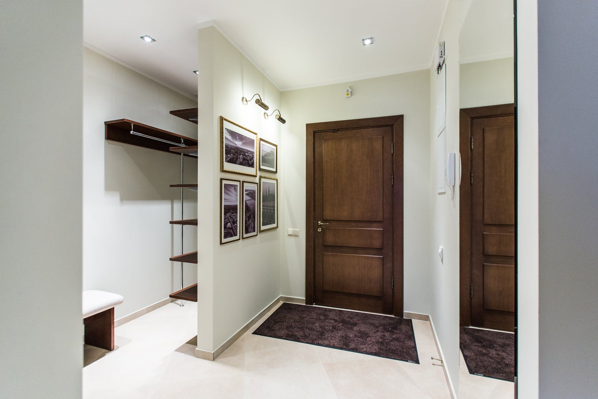 A hallway with a mirror and a wooden door