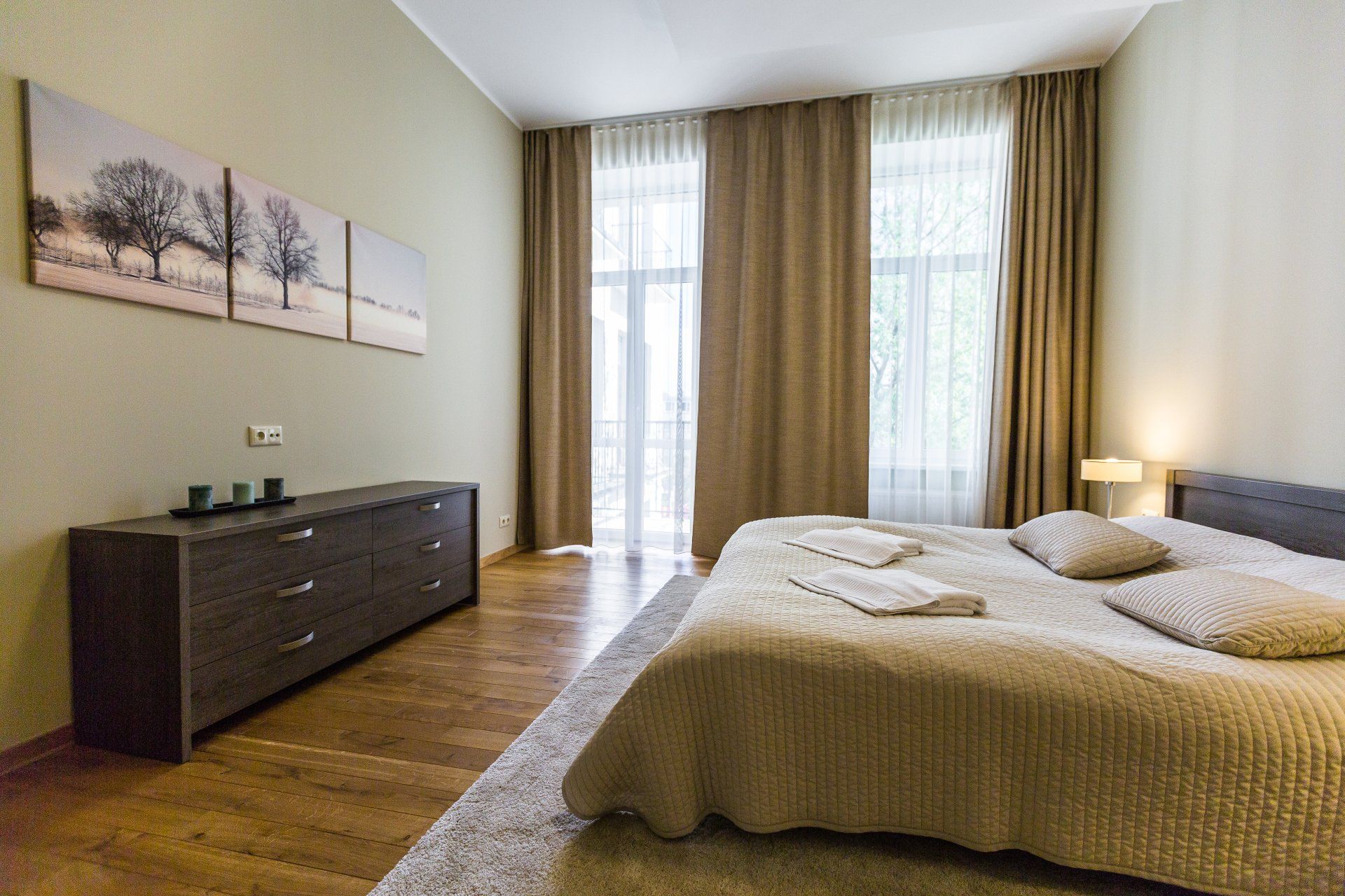 A bedroom with a large bed and a dresser.
