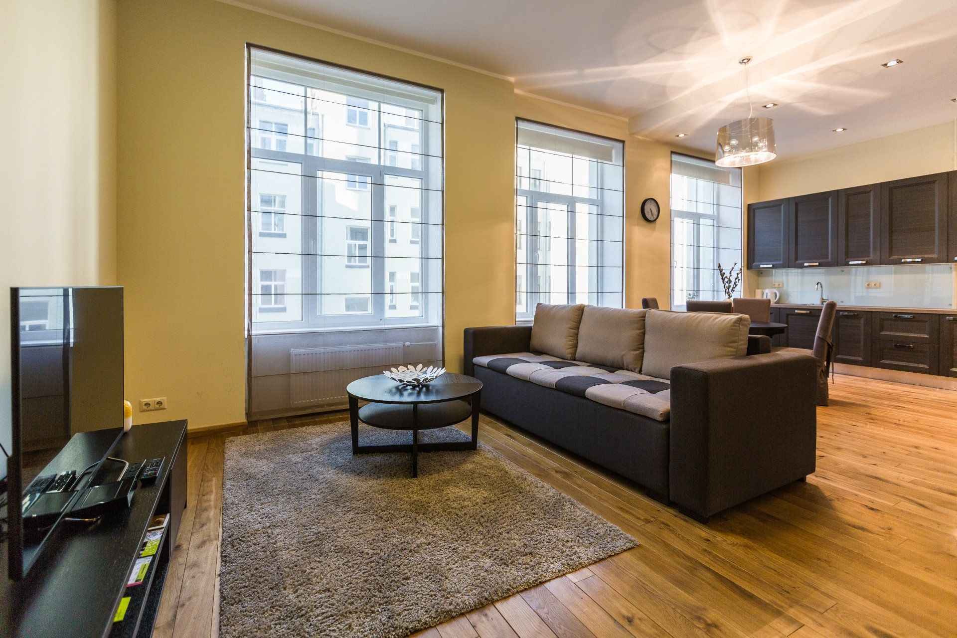 A living room with a couch , coffee table , and television.