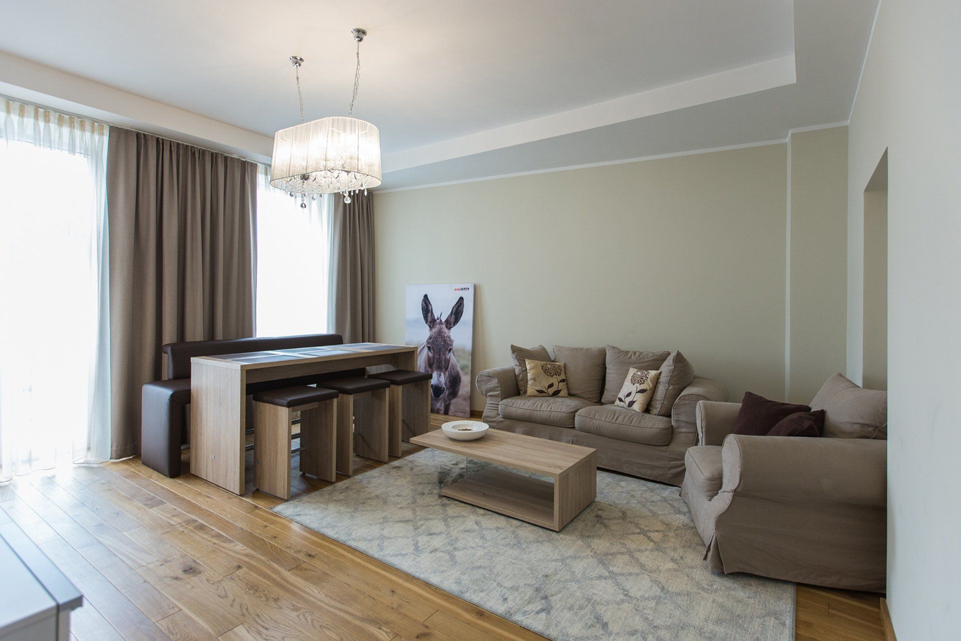 A living room with a couch , chairs , and a coffee table.