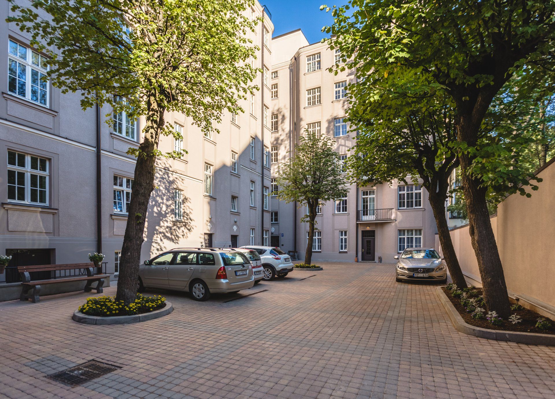 A parking lot with cars parked in front of a building