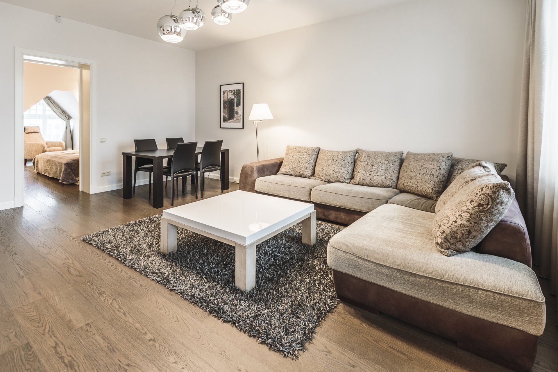 A living room with a couch , table and chairs