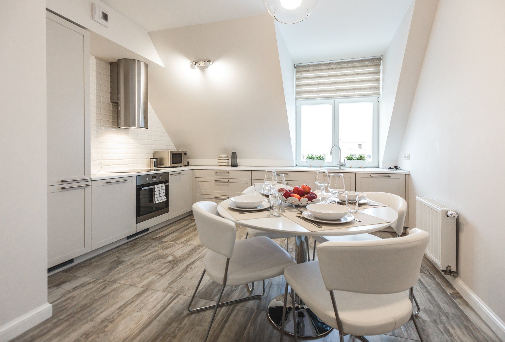 A kitchen with a table and chairs in it.