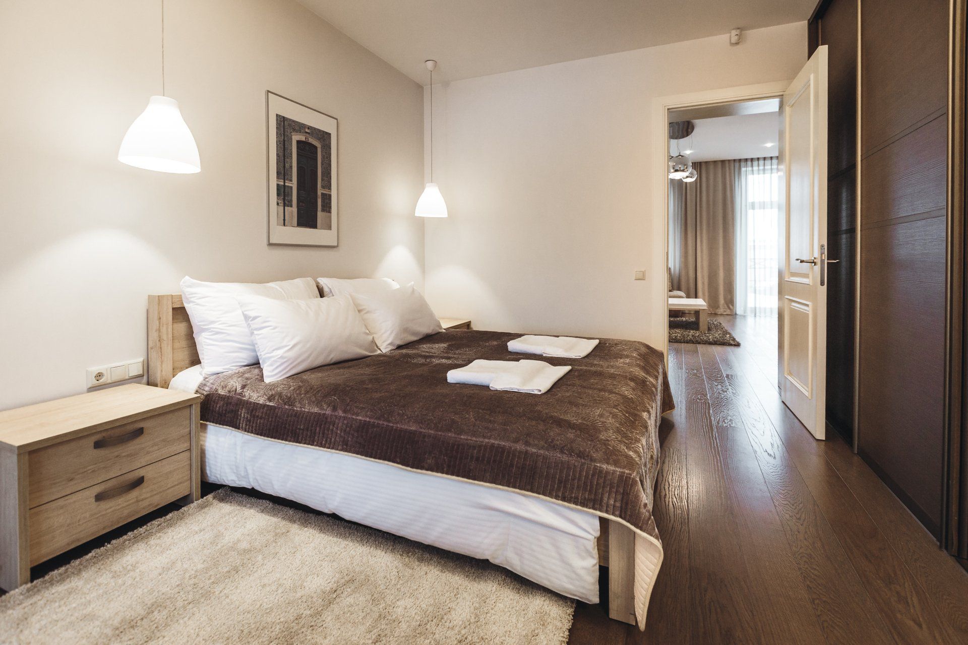 A bedroom with a large bed , nightstand , and rug.