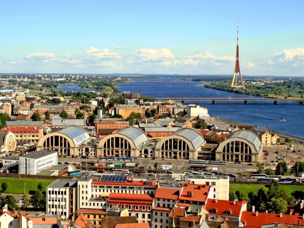 An aerial view of a city with a river in the background