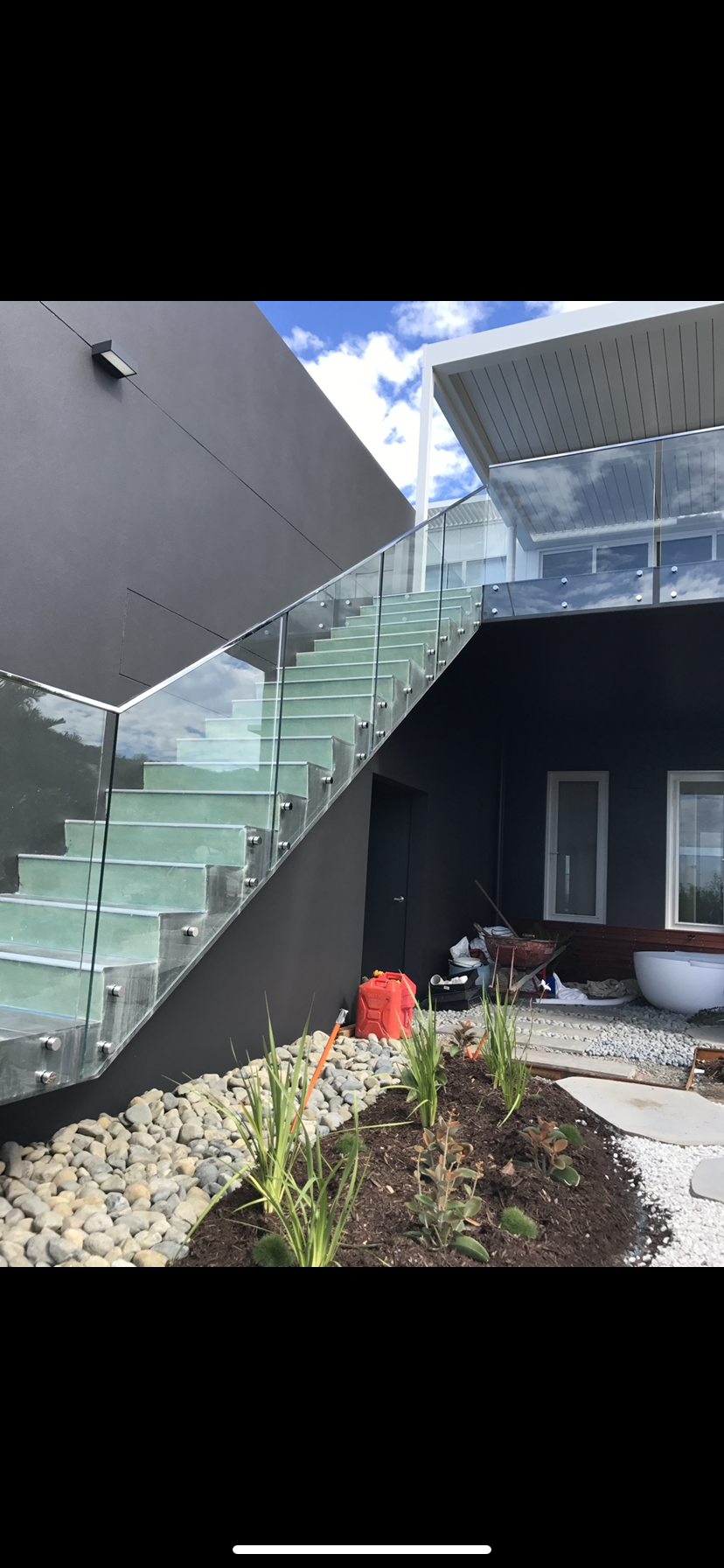 A glass staircase is going up to the second floor of a building — Fabricator In Coffs Harbour, NSW