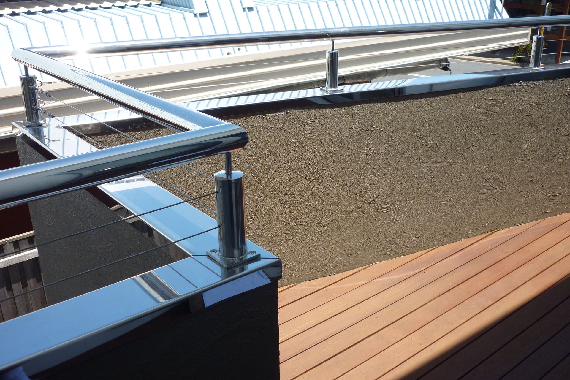 A balcony with a stainless steel railing and a wooden deck — Fabricator In Coffs Harbour, NSW