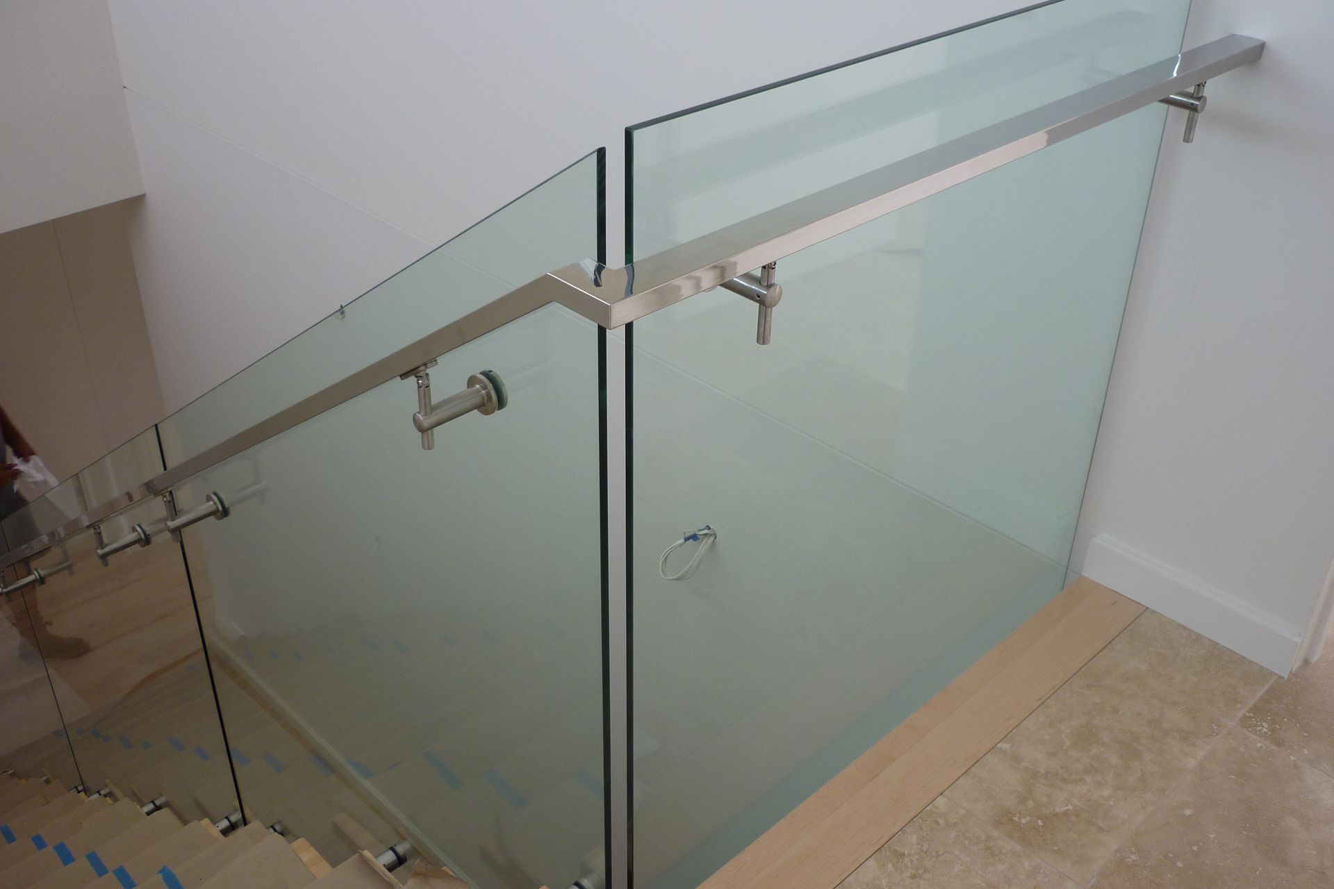 A staircase with a glass railing and a stainless steel handrail — Fabricator In Coffs Harbour, NSW