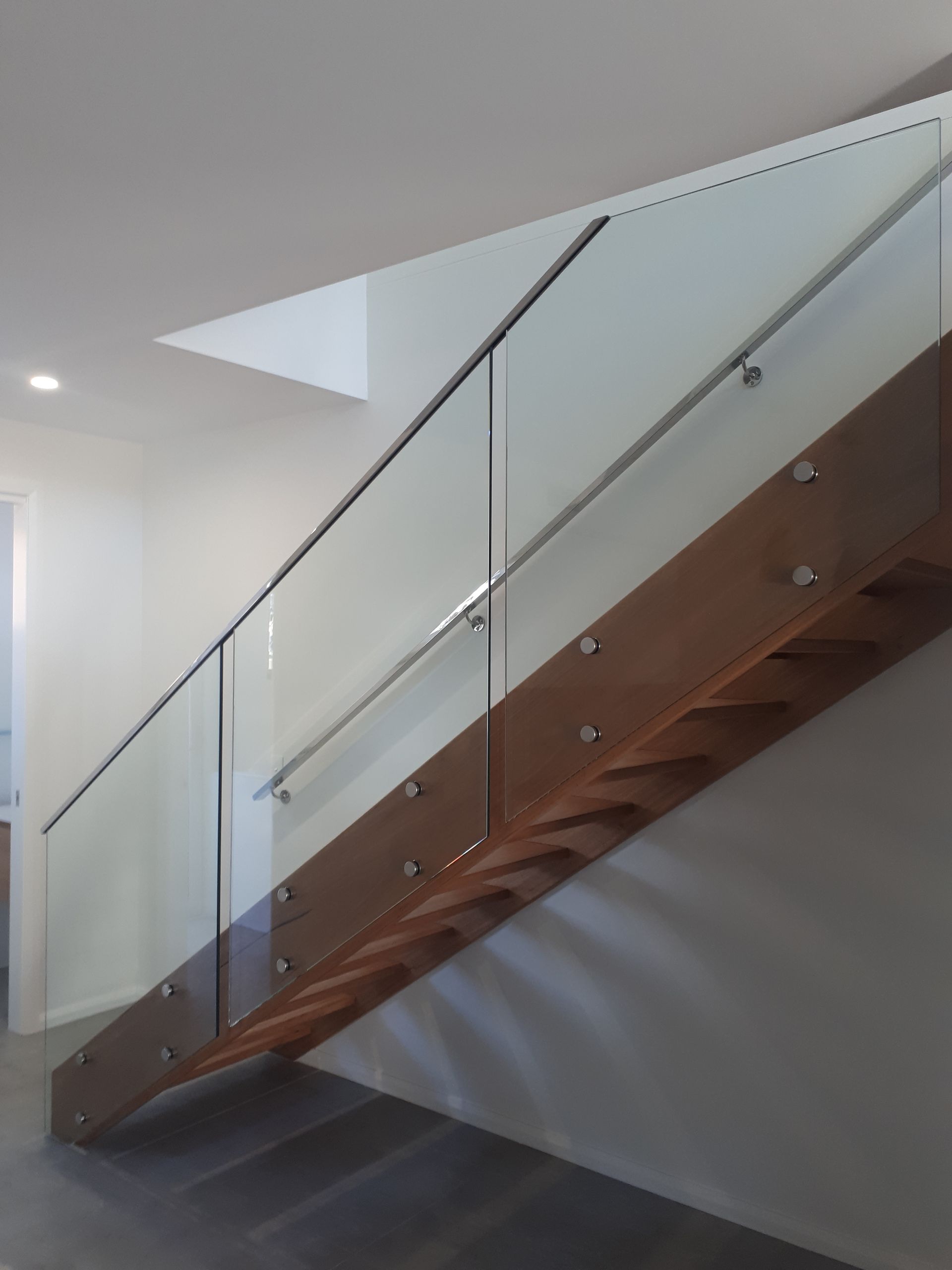 A wooden staircase with a clear glass railing — Fabricator In Coffs Harbour, NSW