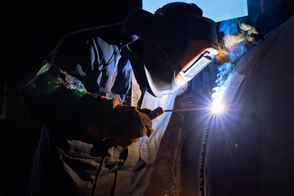 Welder In Protective Gear Welding A Metal Structure