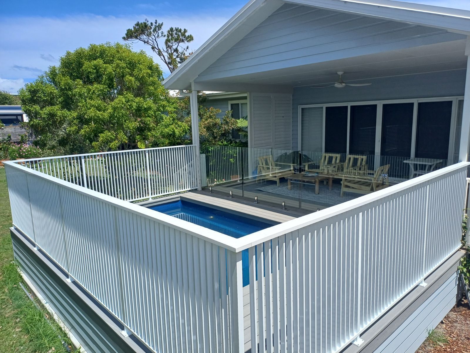 White Aluminum Fence Surrounds A Pool — Fabricator In Coffs Harbour, NSW