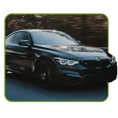 Black BMW sedan driving on a road with motion blur background
