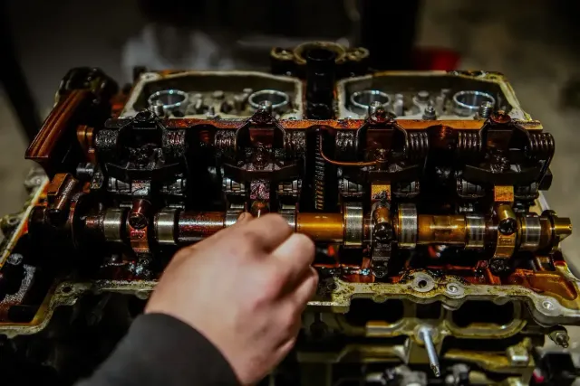 Hands carefully wiring multicolored cables with a tool in a close-up technical repair scene