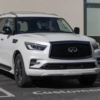 White Infiniti SUV parked in a customer parking space outdoors