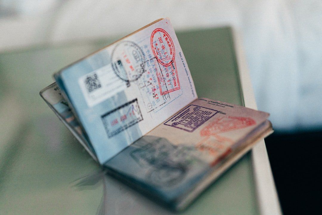 Open passport with visas and stamps on a table