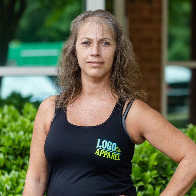 A woman wearing a black tank top that says logo apparel