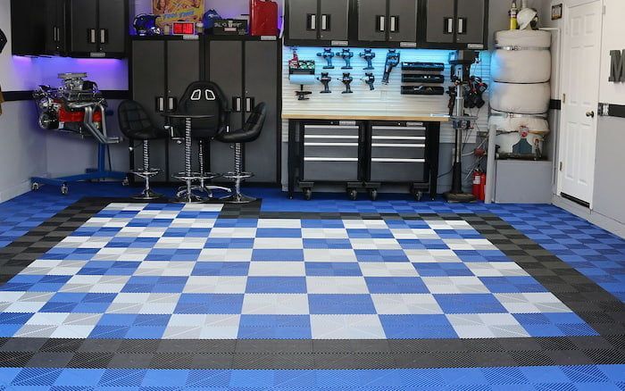 Modern garage with blue checkerboard floor and workbench in the background