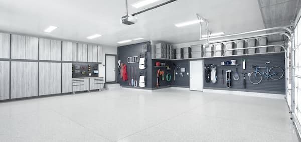 Bright modern garage interior with cabinets, tools, and bicycles along the walls