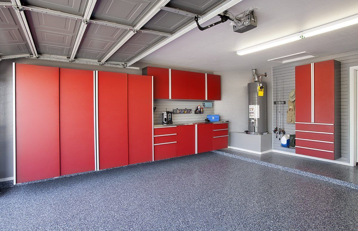 Empty garage with red storage cabinets and a gray speckled floor
