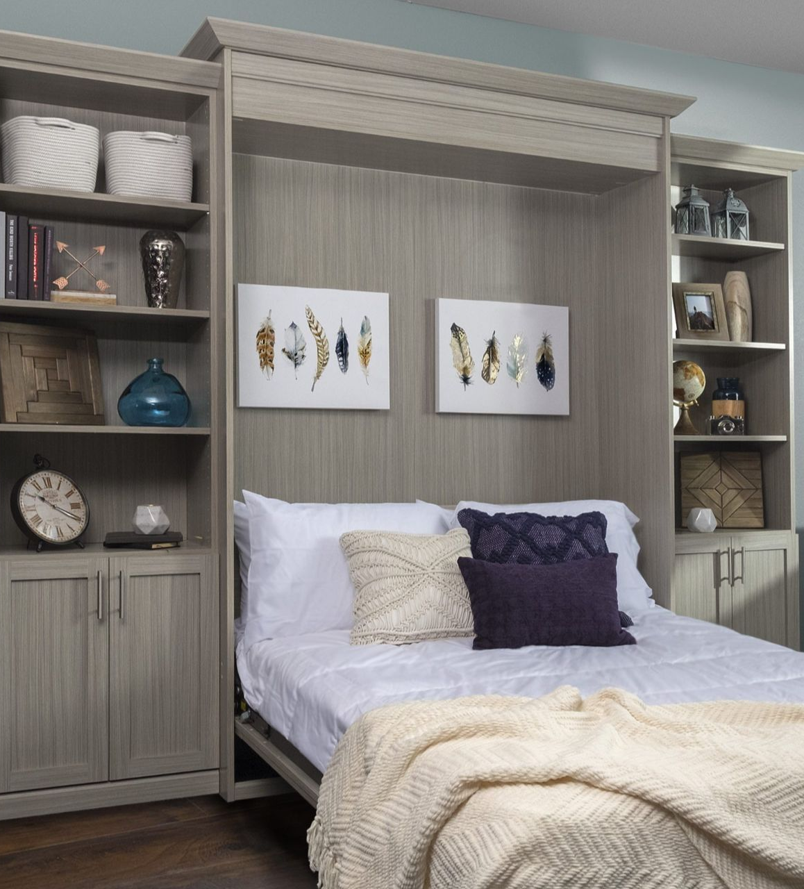 Grey walk-in closet with desk area. Includes hanging clothes, shelves, and a chair.