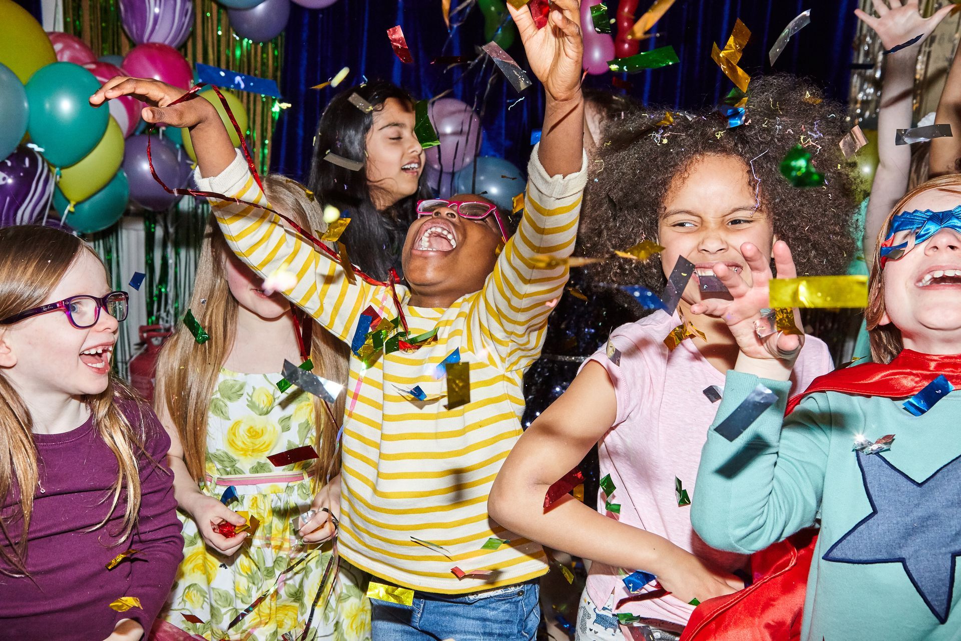 A group of kids celebrates and has fun in a birthday party.