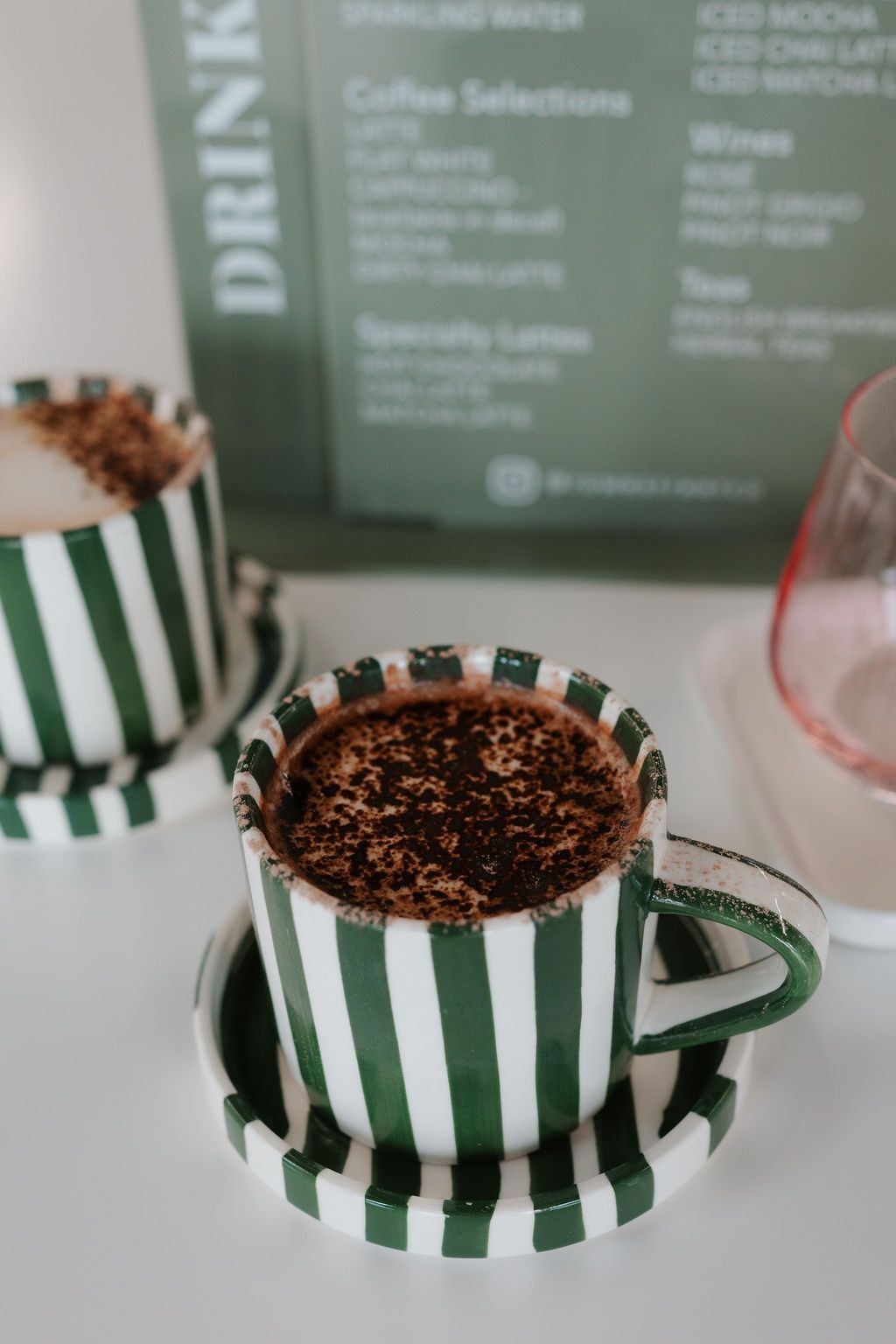A tray with a teapot , cup and donut on it in a salon. — Rowe Street Collective In Shepparton, VIC