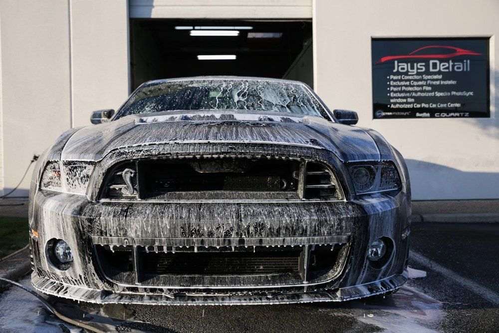 Ford Mustang covered in soap suds, at Jays Detail shop.