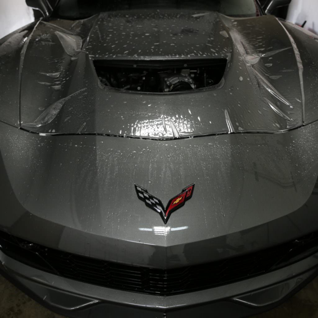 Gray Corvette with film protection on the front. Features the Corvette logo.
