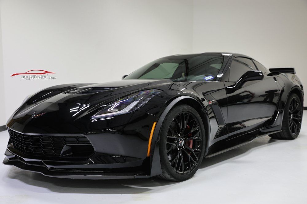 Black Chevrolet Corvette sports car in a showroom.