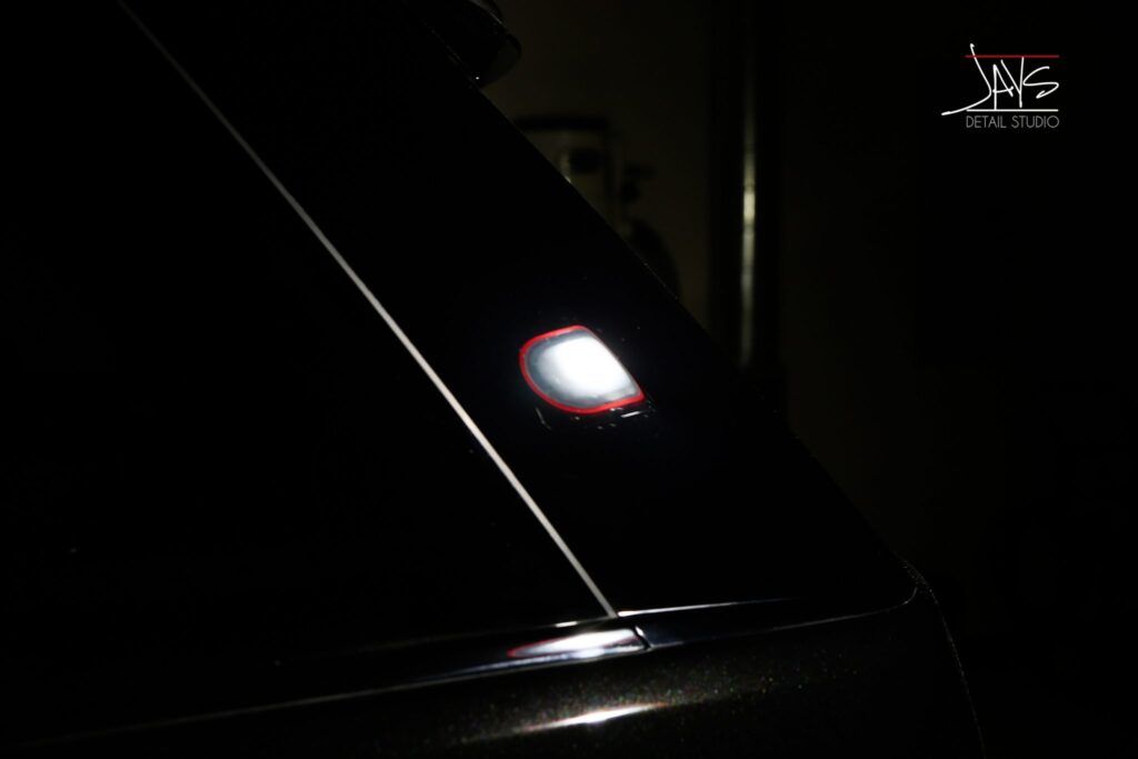 Bright white light on a dark car.