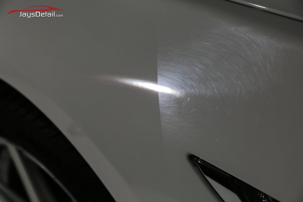 Car panel: before and after polishing. Scratches on the right side are removed on the left, creating a glossy finish.