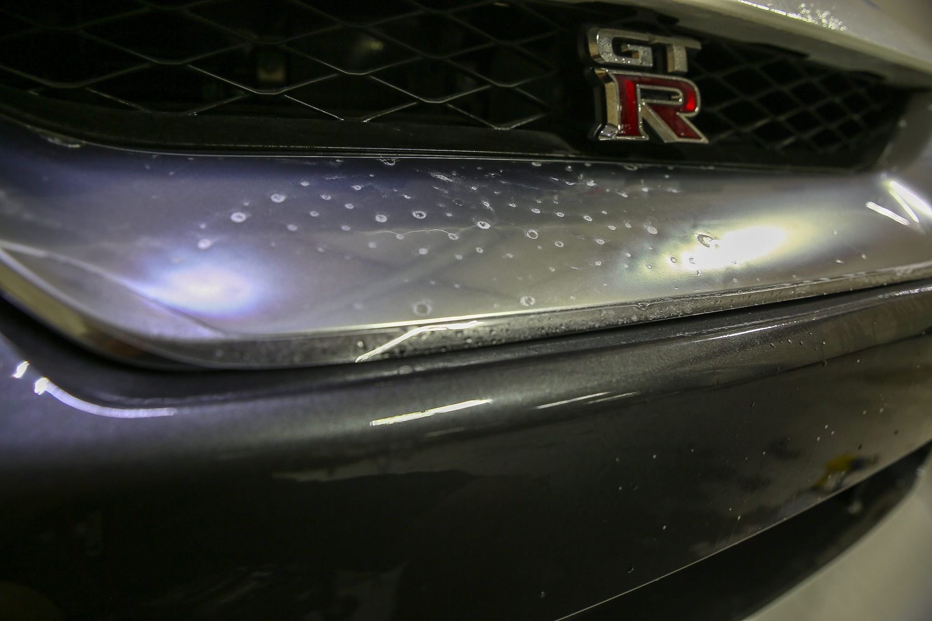 Close-up of a gray Nissan GT-R front bumper with the