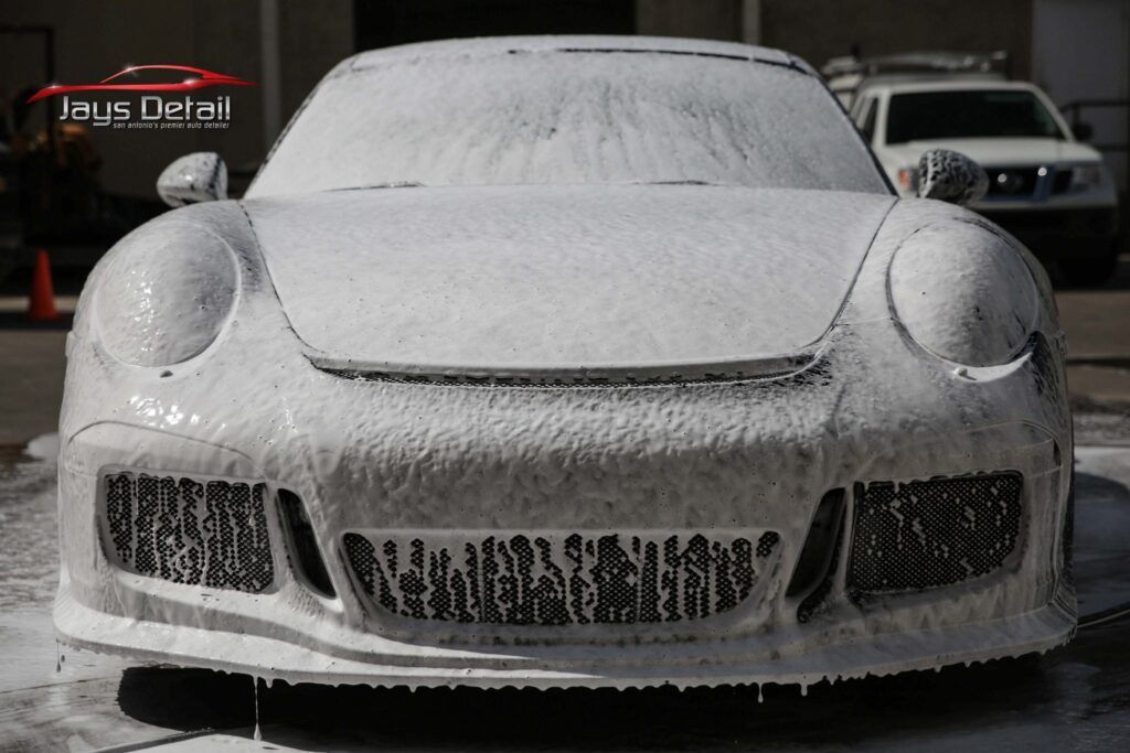 Porsche covered in white foam during a car wash at Jays Detail.