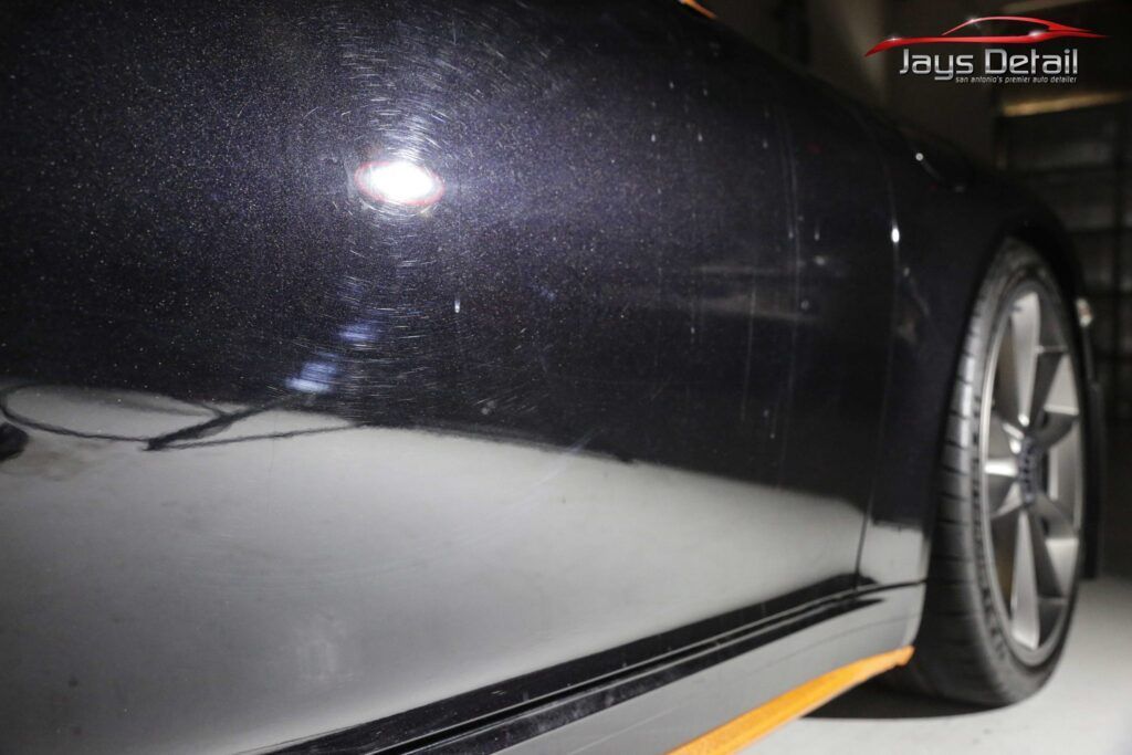 Black car side with visible swirl marks; Jay's Detail logo in the top right.