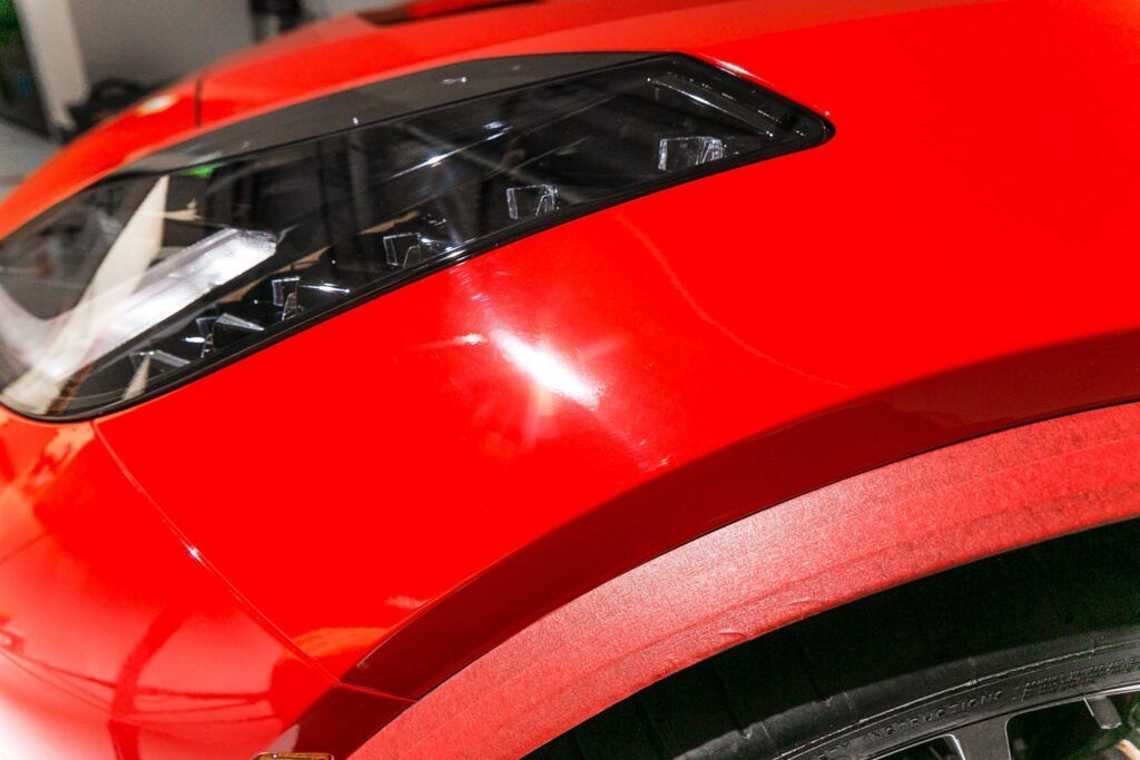 Red car body with a black trim detail; slight scratch visible.