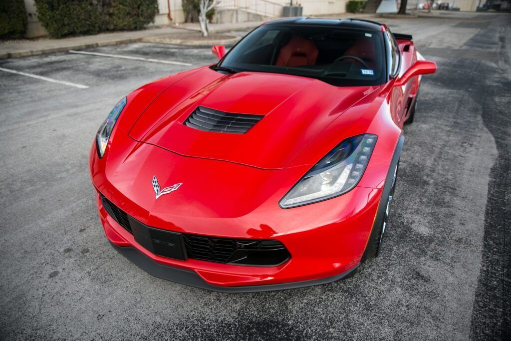 Red Corvette sports car parked on asphalt.