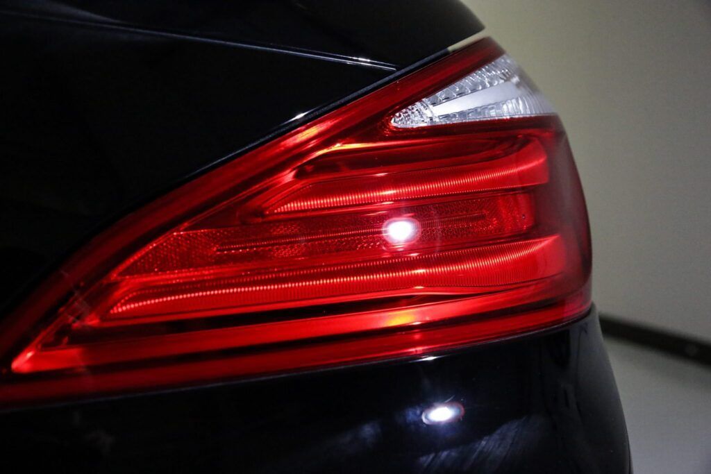 Red taillight on a black car.