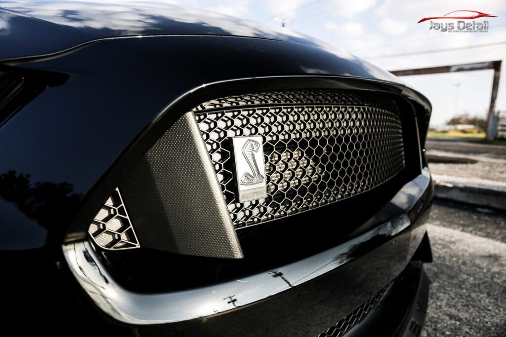Black Ford Mustang Shelby GT350 front grill with cobra emblem.