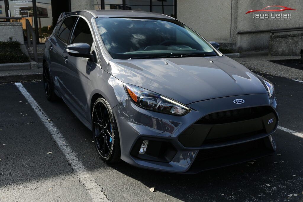 Gray Ford Focus RS parked in a parking space, front view.