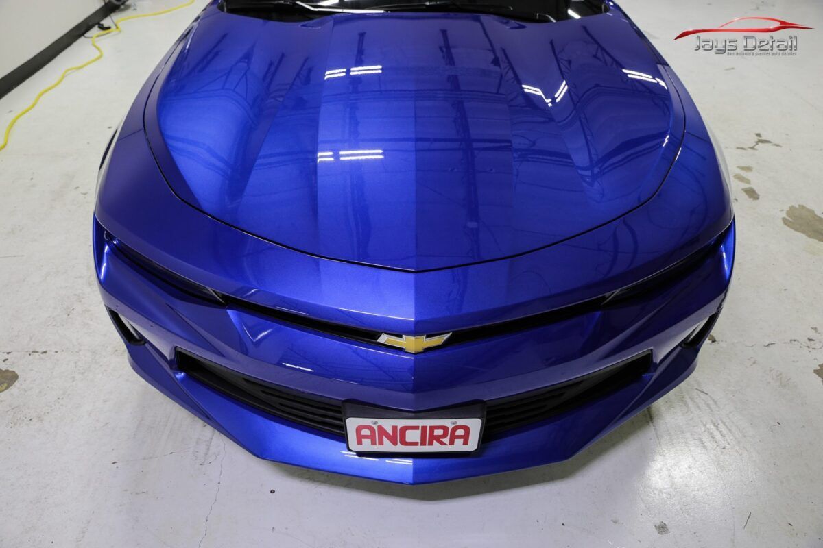 Blue Chevrolet Camaro front view. Showing grill, logo, and license plate that says