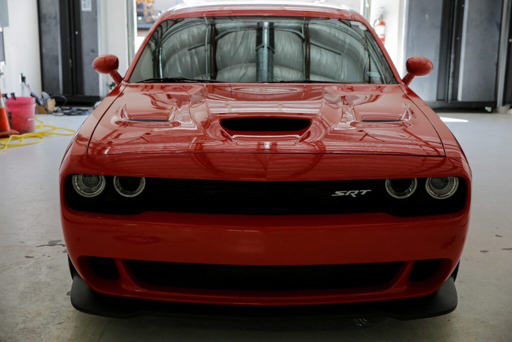 Red Dodge Challenger SRT front view.