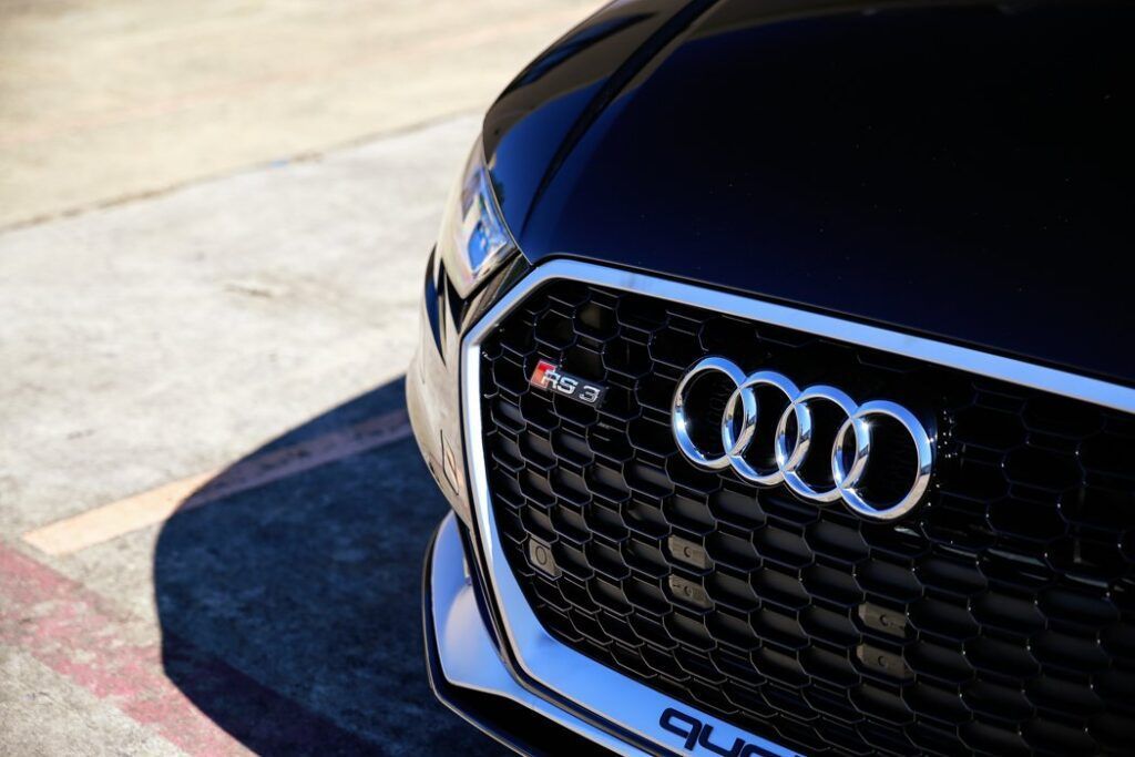 Black Audi RS3 with silver grill and logo, parked outdoors.