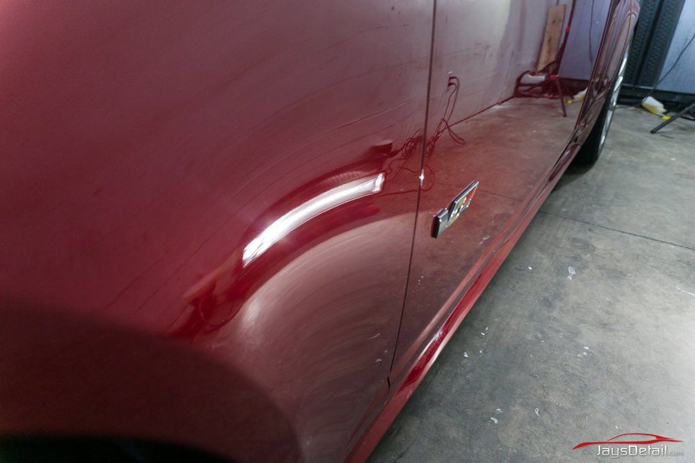 Red car door with reflection and