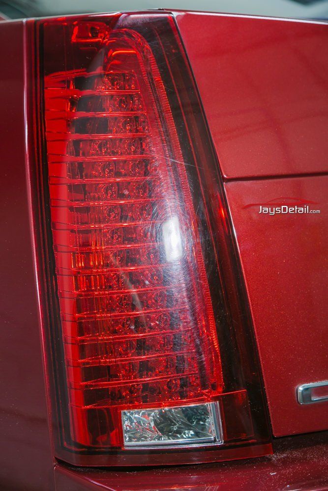 Red car taillight with vertical red lights and a white reverse light.
