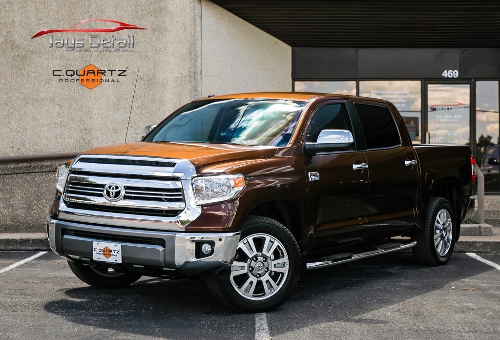 Brown Toyota Tundra pickup truck parked in front of a building.
